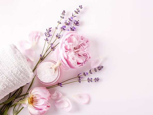 selection of flowers, bath salts and towel